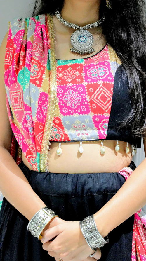 A black lehenga (skirt) with colorful, patterned patches and shell embellishments -set of 3