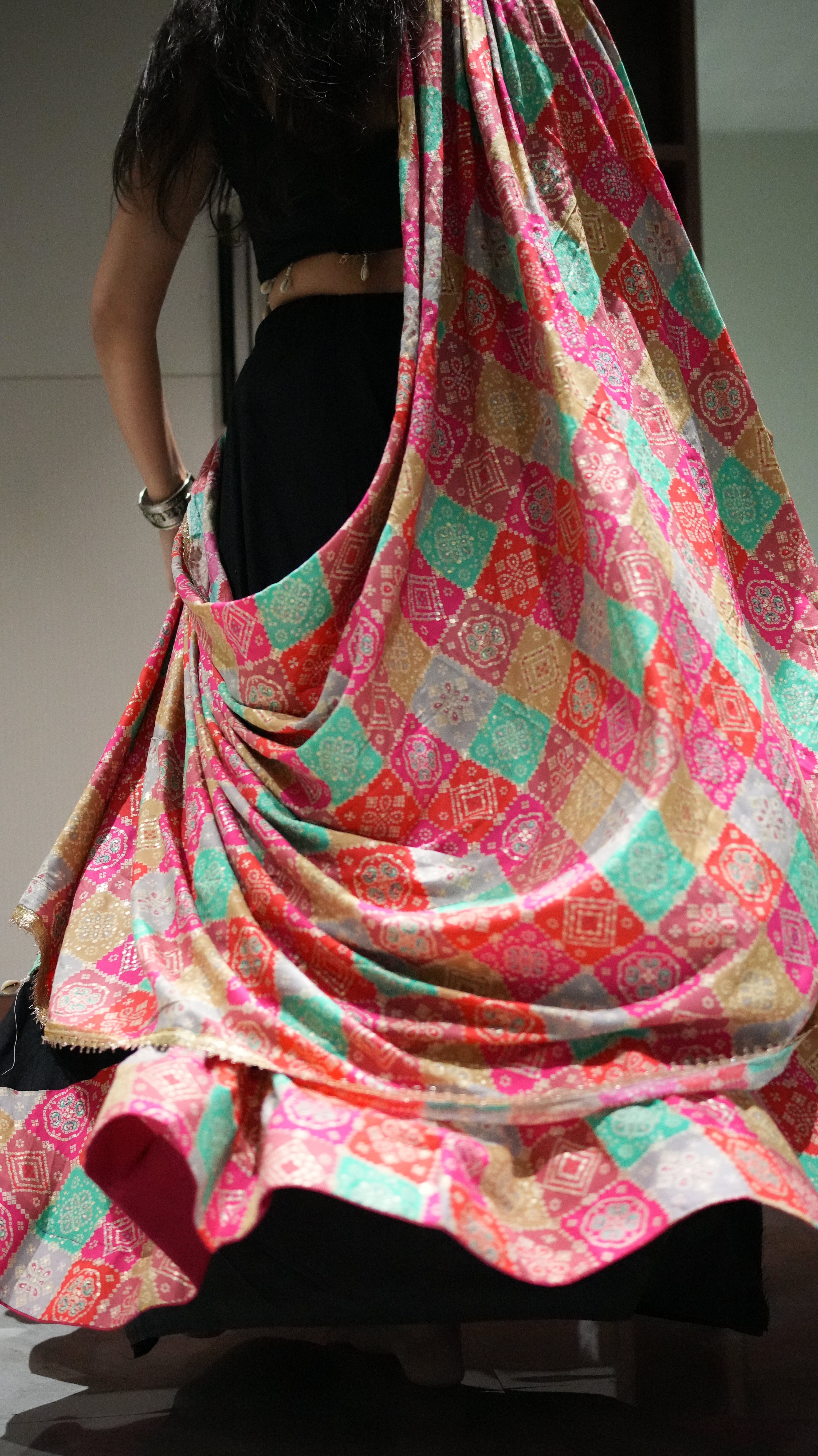 A black lehenga (skirt) with colorful, patterned patches and shell embellishments -set of 3